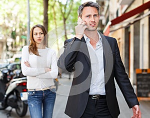 Man ignoring frustrated girl