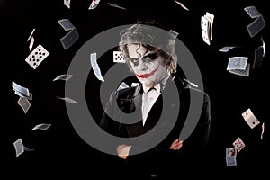 Man in an image of a joker with fly cards