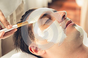 Man indulges in rejuvenating with luxurious face cream spa massage. Quiescent