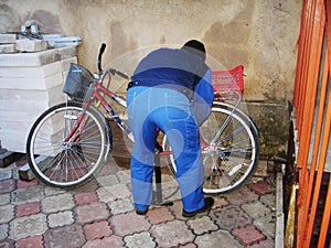 a man inflates a bicycle wheel pump