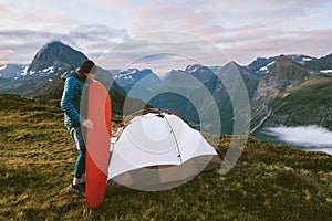 Man inflating sleeping pad in mountains camping gear tent outdoor Travel hiking in Norway adventure healthy lifestyle