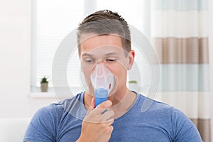 Man Inhaling Through Inhaler Mask