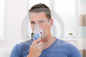 Man Inhaling Through Inhaler Mask