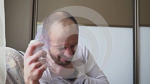 Man inhaling through inhaler mask in the room.