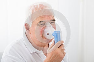 Man Inhaling Through Oxygen Mask