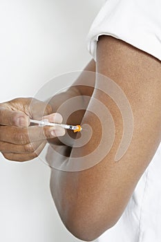 Man Injecting Insulin Using Syringe photo