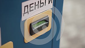 Man Inserting Cash Into Machine At Parking Lot close-up. Clip. Hand inserting banknote into vending machine