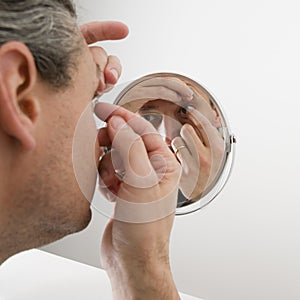 Man inserting a contact lens