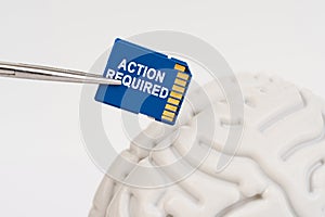 A man inserts a memory card into his brain with the inscription - Action Required