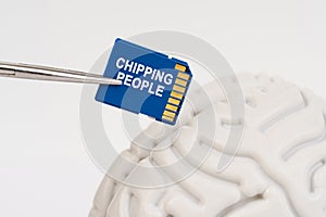 A man inserts a memory card into his brain with the inscription - chipping people