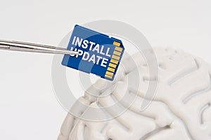 A man inserts a memory card into his brain with the inscription - Install Update