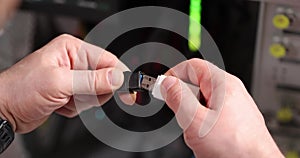 Man inserts USB flash drive into USB cable adapter slow motion 4k movie