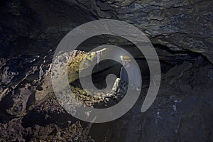 Man Inside Lava Tube Cave In Oregon
