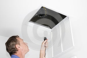 Man Inspecting Air Intake Duct photo