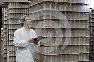 Man inspecting bottled water in distribution warehouse
