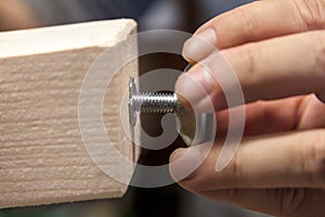 A Man is installing a adjustable screw