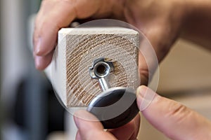 A Man is installing a adjustable screw