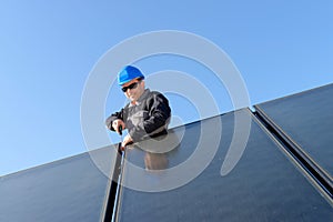 Man installing alternative energy photovoltaic pan