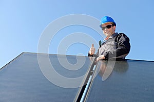 Man installing alternative energy photovoltaic pan