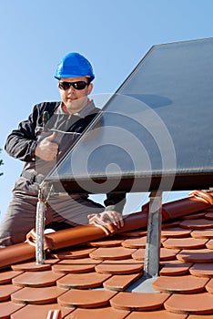 Man installing alternative energy photovoltaic sol