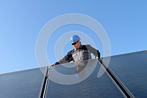 Man installing alternative solar energy photovolta