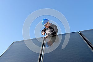 Man installing alternative solar energy photovolta