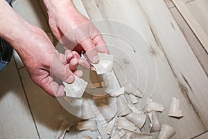 Man is installing the baseboard. Repair works indoors. Renovation in the flat