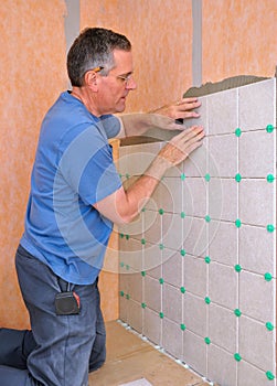 Man installing ceramic tile