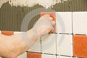 Man installing ceramic tile