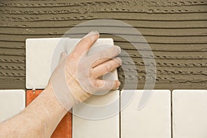 Man installing ceramic tile