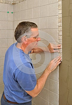 Man installing ceramic tile border