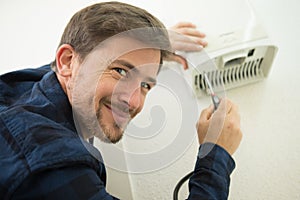 man installing electric hand-dryer