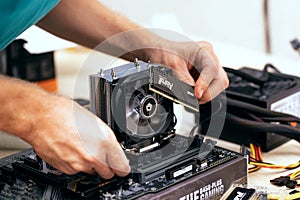 man installing Fury Beast RAM DDR4 stick on professional PC. Russia, 17.08.2021
