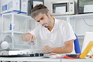 Man installing induction hobs in kitchen