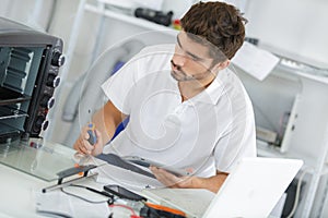 Man installing induction hobs in kitchen