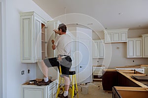 Man installing kitchen cabinets door