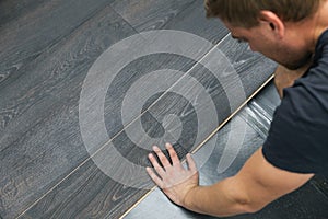 Man installing laminate floor