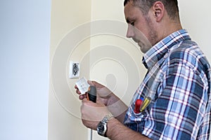 Man installing light switch