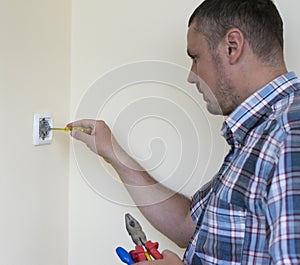 Man installing light switch