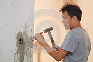 Man installing light switch