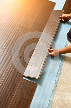 Man Installing New Laminate Wood Flooring