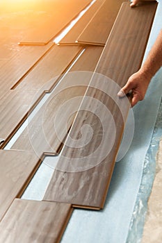 Man Installing New Laminate Wood Flooring