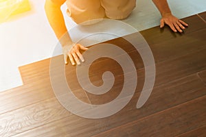 Man Installing New Laminate Wood Flooring