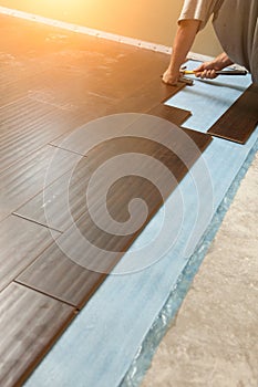 Man Installing New Laminate Wood Flooring