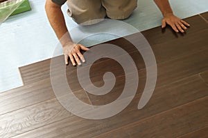 Man Installing New Laminate Wood Flooring