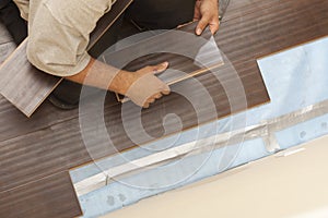 Man Installing New Laminate Wood Flooring