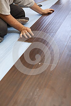 Man Installing New Laminate Wood Flooring