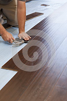 Man Installing New Laminate Wood Flooring