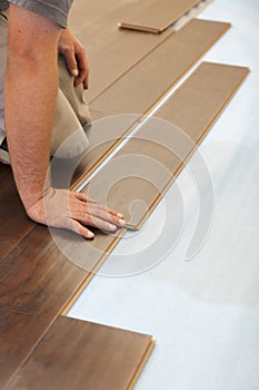 Man Installing New Laminate Wood Flooring