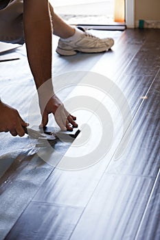 Man Installing New Laminate Wood Flooring